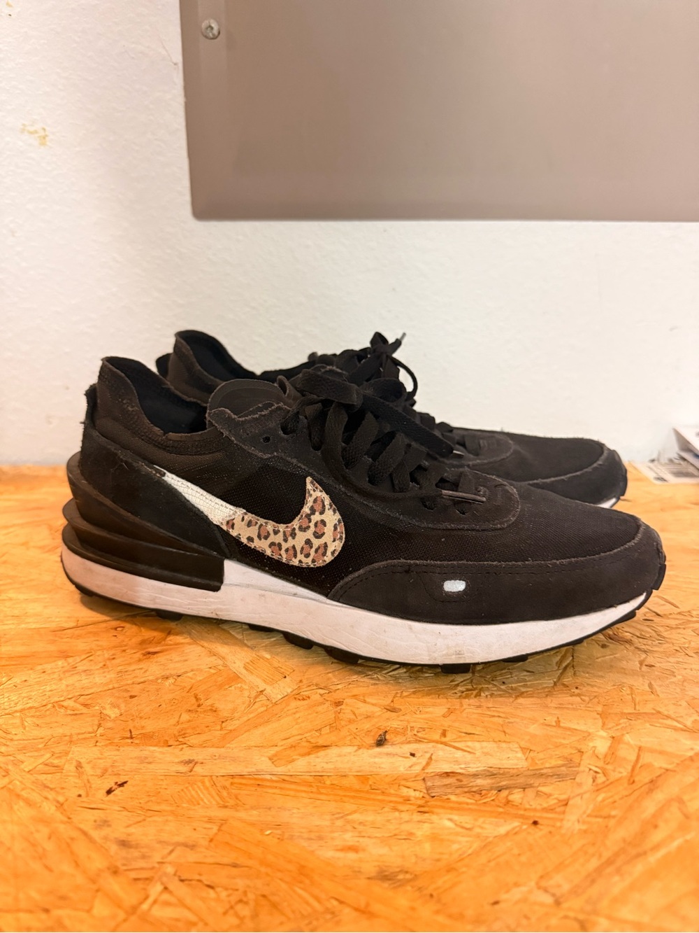 Nike Men’s Black Sneakers with Leopard Swoosh Accent